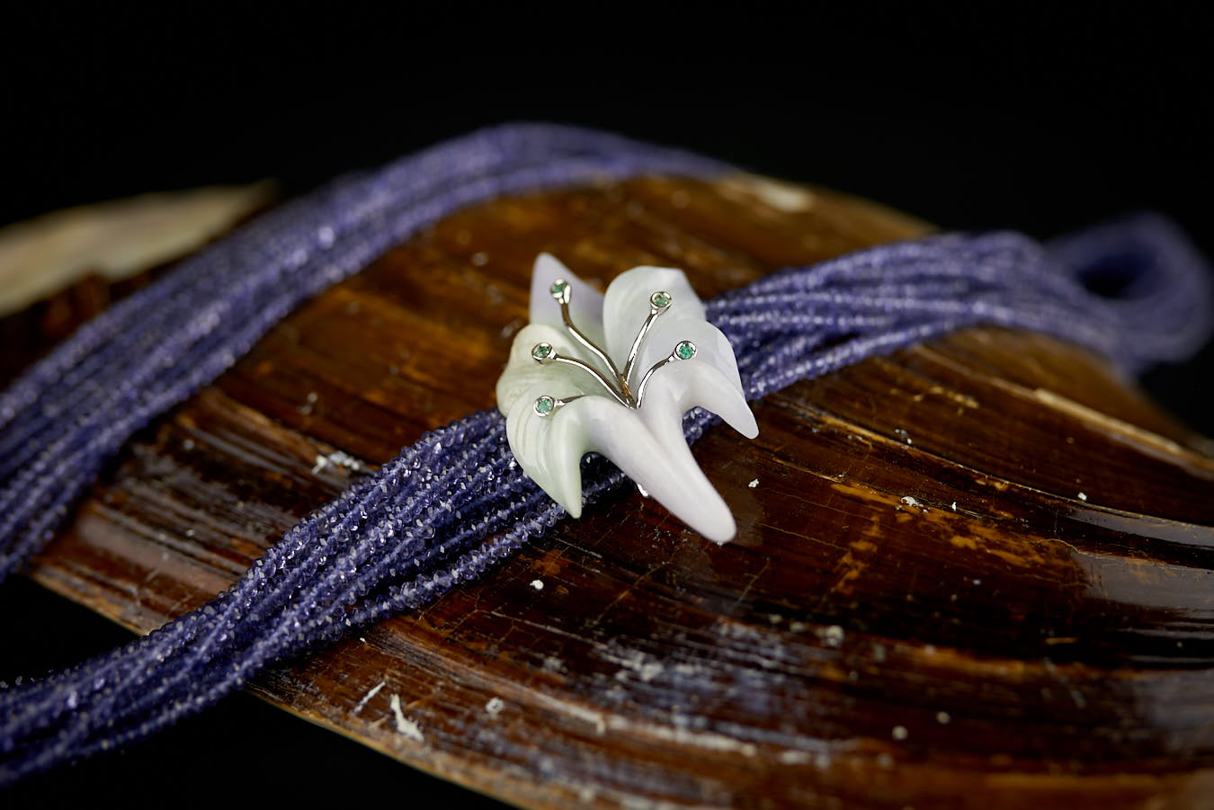 Multi-strand necklace of natural iolite brooch with natural lavender jadeite jade mounted in white gold with emeralds
